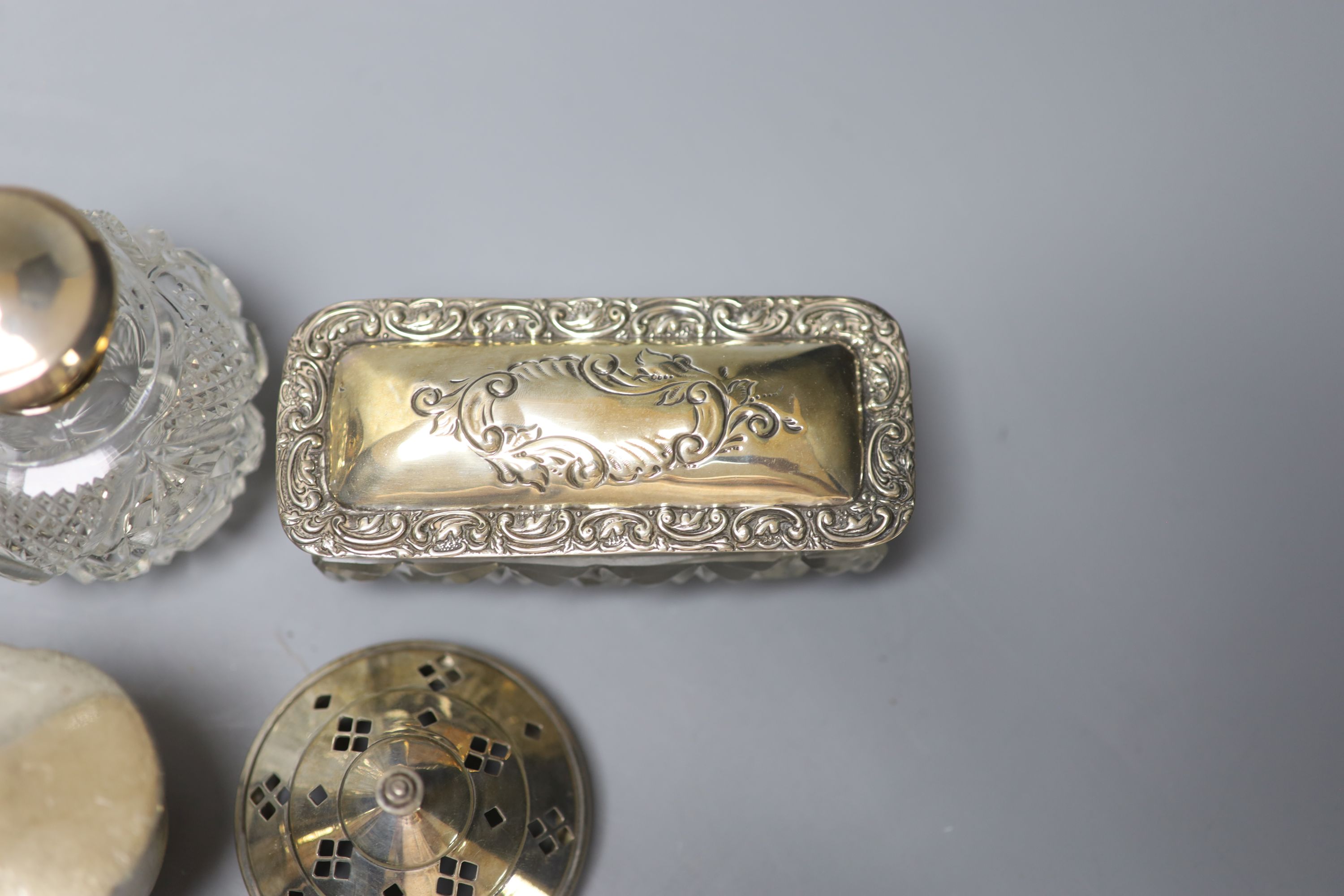 A George V silver oval trinket box, 12.5cm, a silver toilet canister and other toilet jars etc.